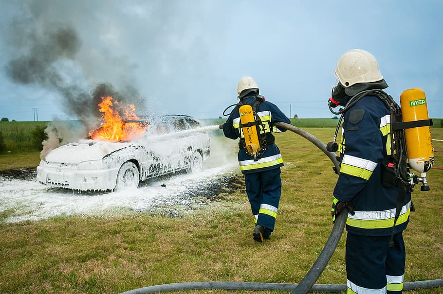 two, firefighters, fighting, fire, grey, station wagon, field, daytime, firefighter, extinguish