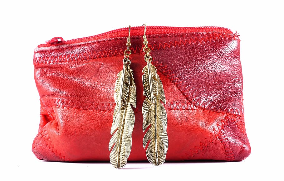red, leather coin purse, pair, gold-colored feather hoop earrings, purse, handbag, fashion, bag, style, design