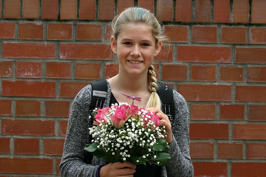 woman, holding, bouquet, pink, roses, smiling, brick, wall, portrait, human