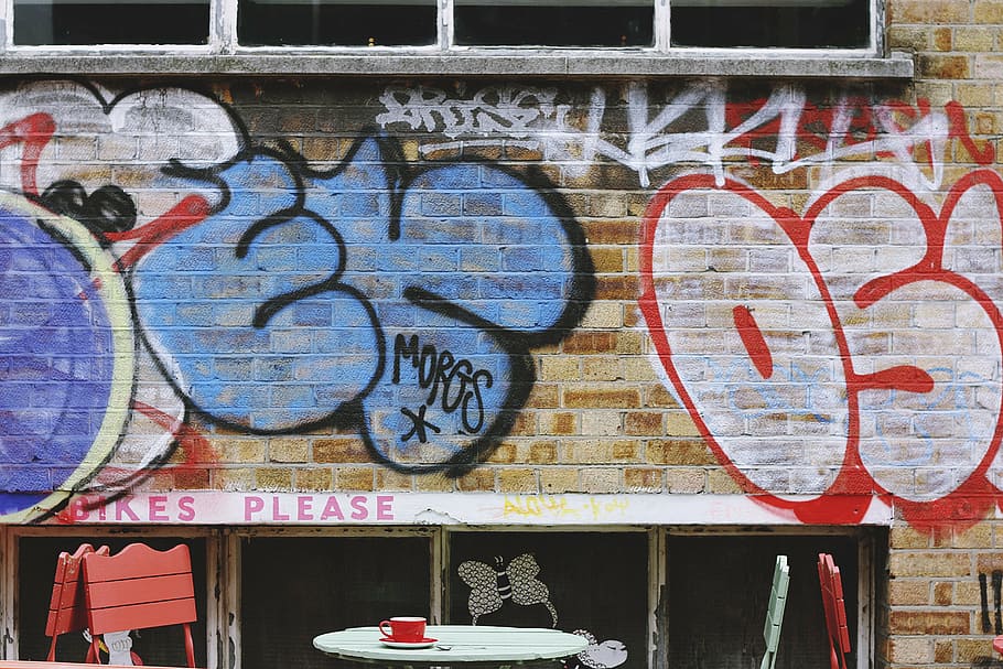 graffiti wall, wall, bricks, paint, vandal, art, letters, table, chairs, cup