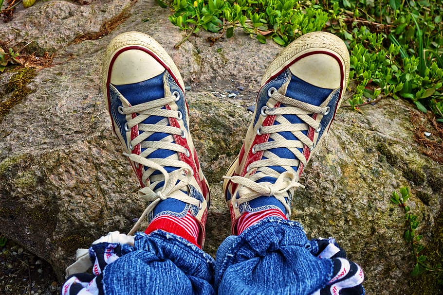 person, wearing, red-blue-and-white low-top sneakers, foot, shoe, sneaker, footwear, woman, female, fashion