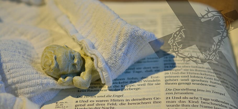 lying, baby figurine, white, cloth, book page, child, christianity, jesus, christ, christmas time