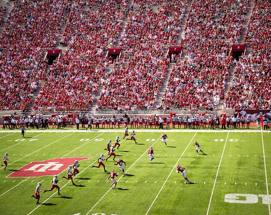 man playing football, football, college, field, pitch, sports, athletics, athletes, crowd, audience