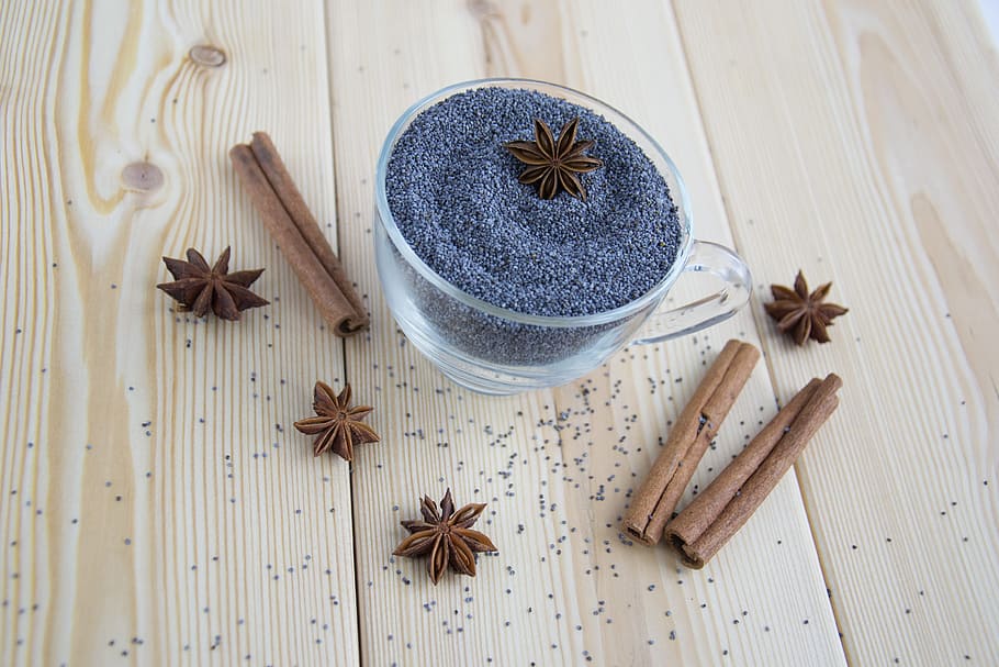 gray, sand, clear, glass tea cup, spices, mack, seeds, seasonings, blue, star anise