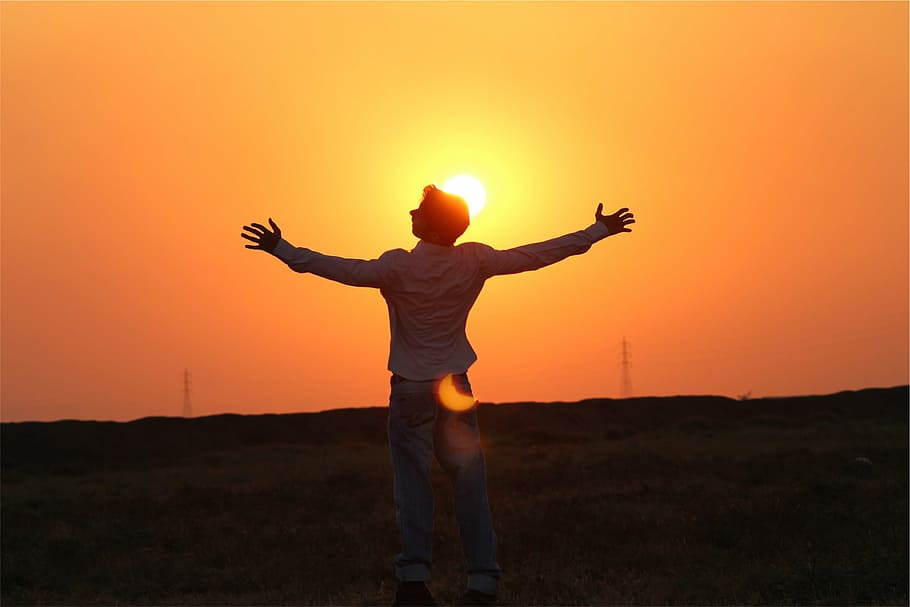 man, white, dress shirt, standing, green, grass field, sunset, silhouette, dusk, sky