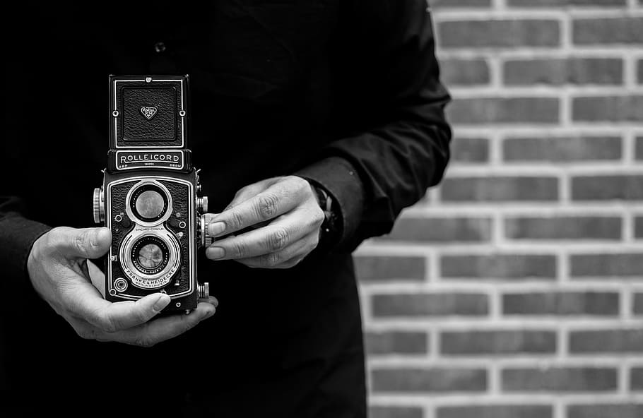 grayscale photo, person, holding, double, lens camera, man, camera, rolleicord, watch, taking pictures