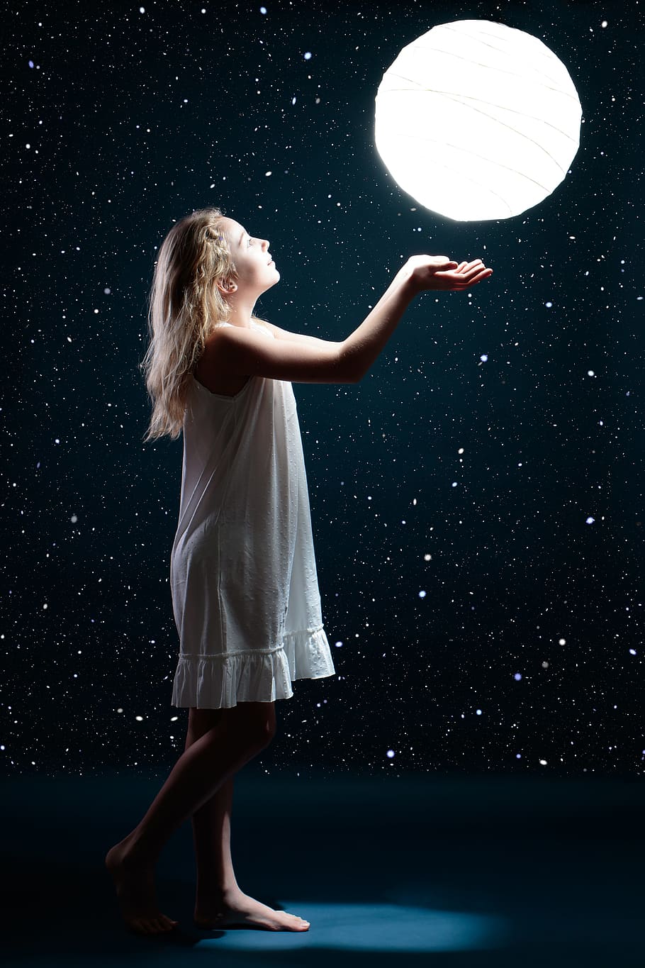 girl, wearing, whit sleeveless dress, looking, round, white, hanging, paper lamp, moon, star