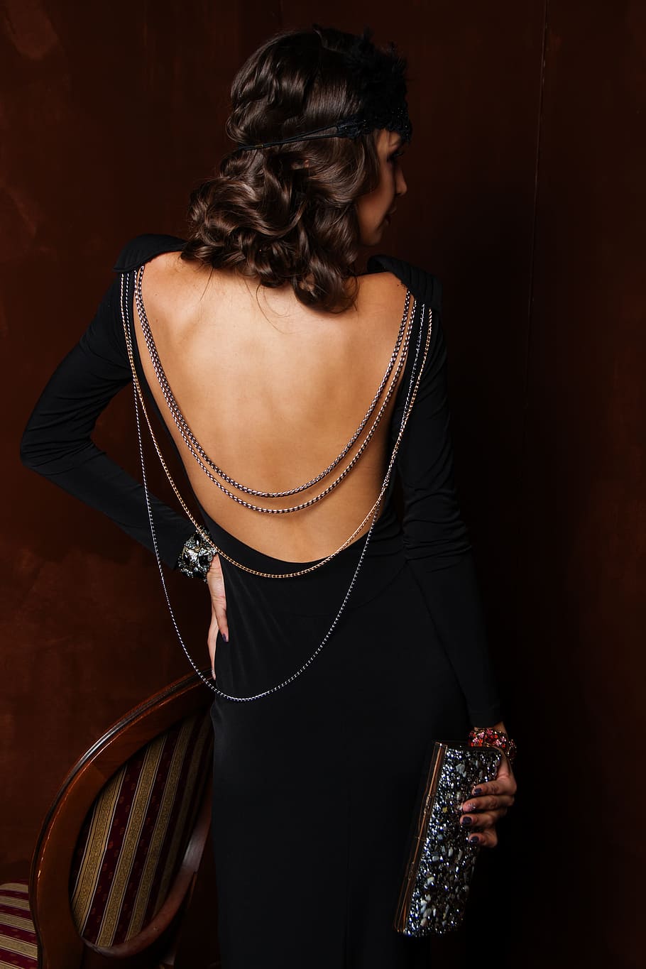 woman, wearing, black, long-sleeved, dress, holding, glitter wallet, one, people, grown up