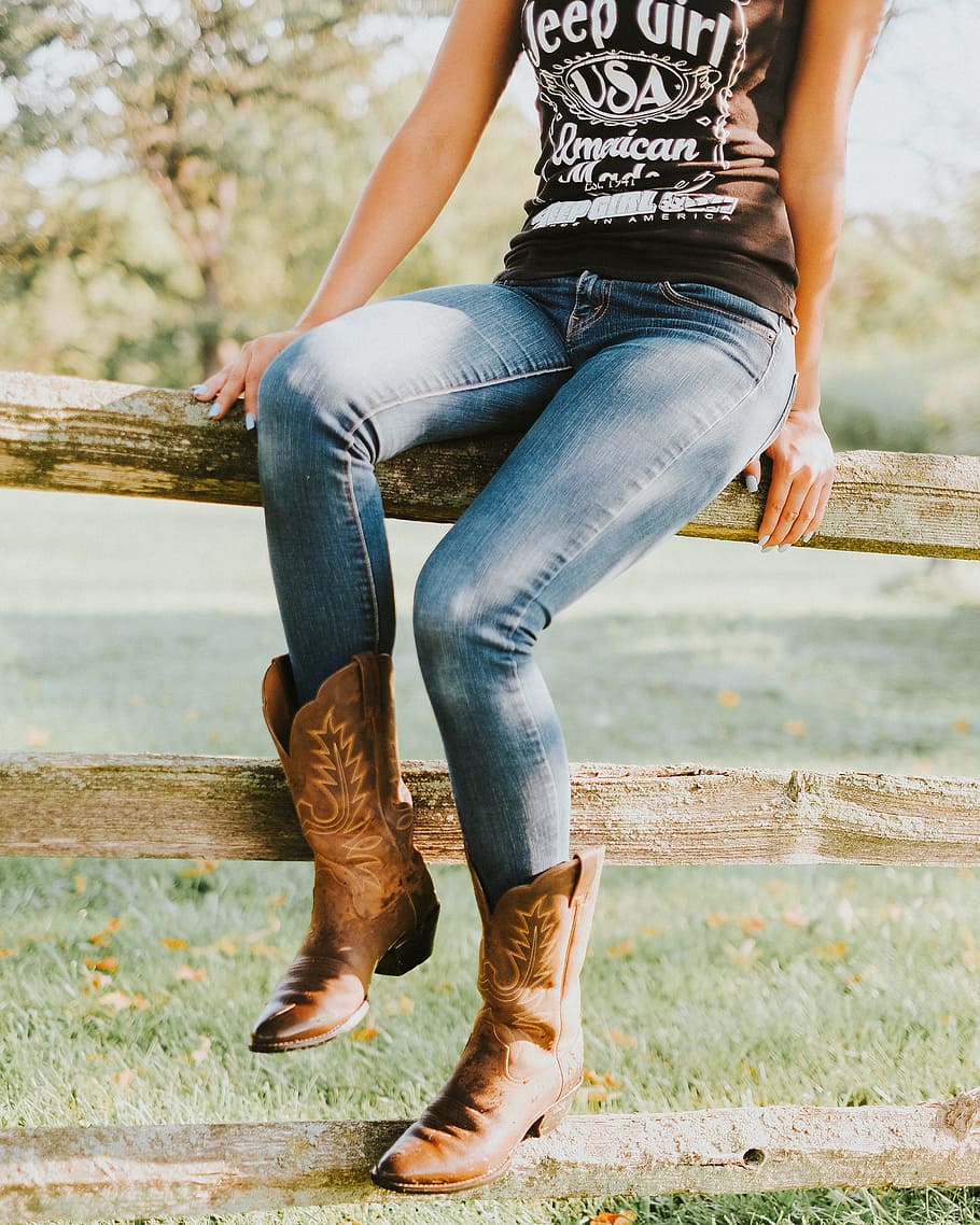 woman, wearing, brown, cowboy boots, sitting, wooden, fence, boots, denim, fashion