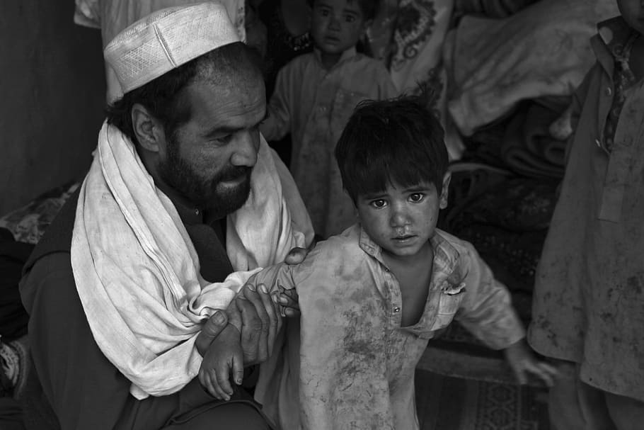 man carrying boy, child, dirty, poor, afghanistan, daddy, father, family, hope, help