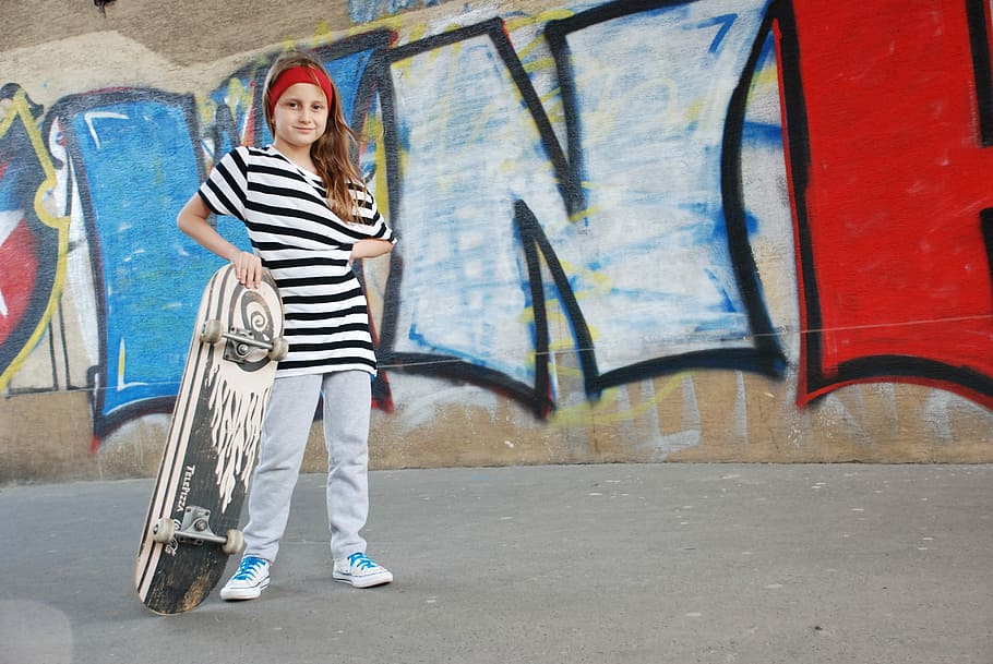 girl, holding, white, black, skateboard, standing, gray, wall, skate, street