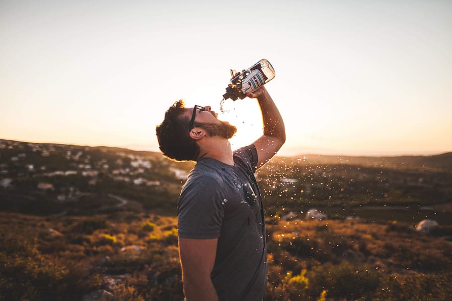 man drinking water, sport bottle, journey, the thirst, mountains, one person, leisure activity, sky, adult, sunset