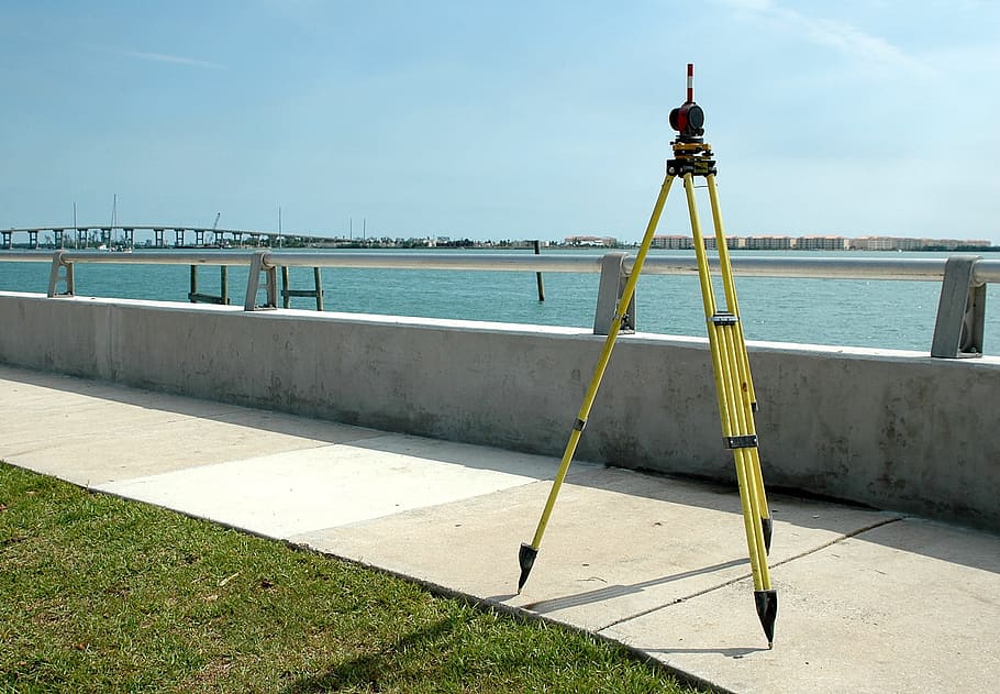 yellow, steel tripod, concrete, walk, path, outdoors, surveying, equipment, measurement, construction