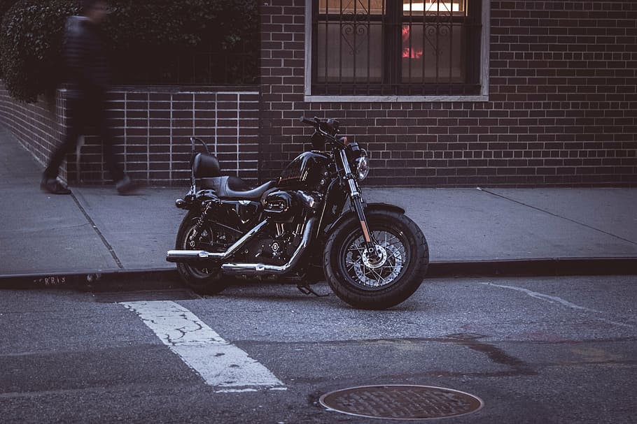 black, cruiser motorcycle, parked, sidewalk, bike, motorcycle, street, pavement, city, transportation