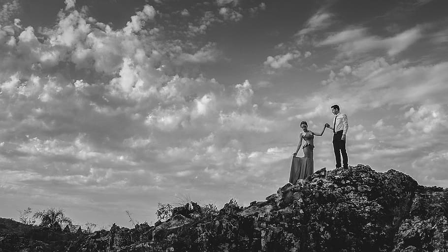 black ang white, couple, love, holding hands, formal, dress, suit, rocks, clouds, sky