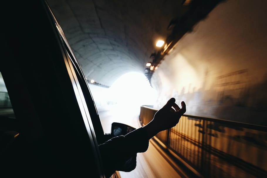 person, right hand, outside, vehicle, window, people, hand, tunnel, car, transportation