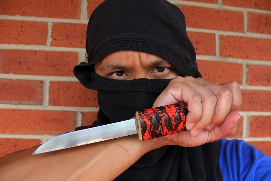 person, holding, knife, brown, brick wall, ninja, assassin, kill, blade, deadly