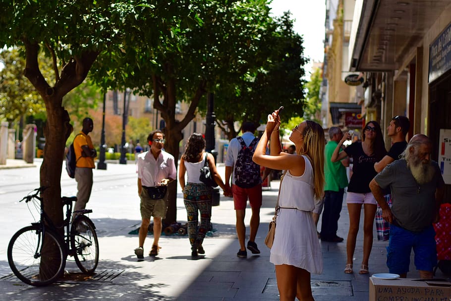 girl, seville, street, phone, sun, people, sidewalk, city, tree, real people