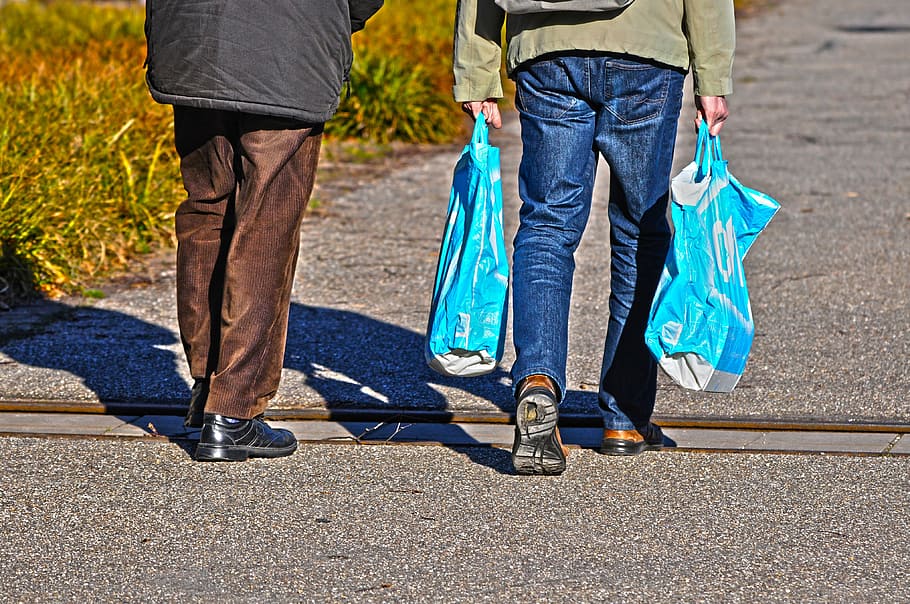 person, carrying, blue, plastic bags, man, people, together, two, two people, walking