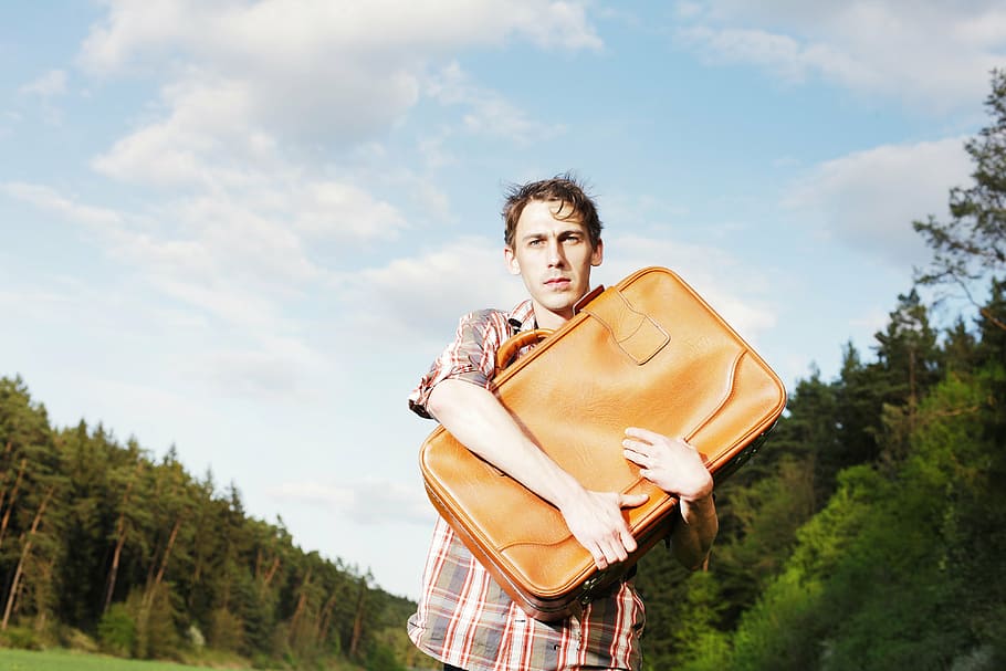 man, holding, leather bag, luggage, forward, young, uncertain, uncertainty, funny, bizarre
