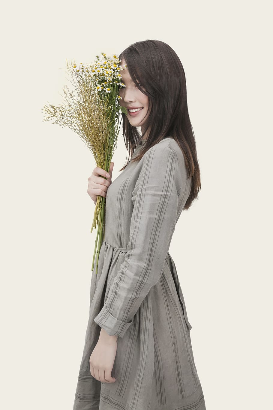 smiling, woman, wearing, gray, long-sleeved, dress, holding, bouquet, flowers, girl