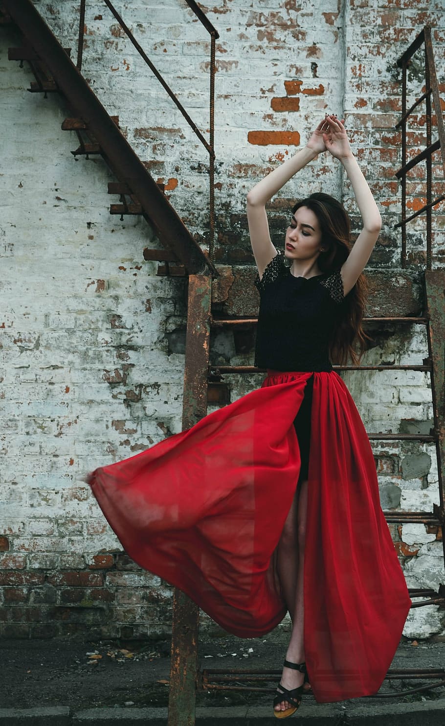 woman, black, red, short-sleeved dress, standing, brown, metal stairs, daytime, girl, dress