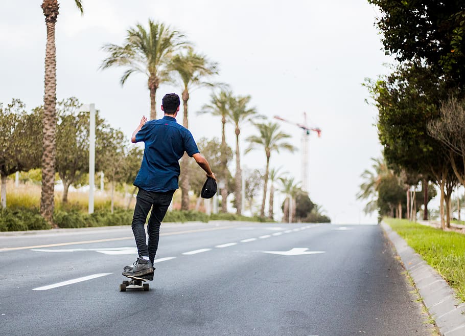 man, stands, skateboard, road, trees, daytime, skate, green, skating, sport
