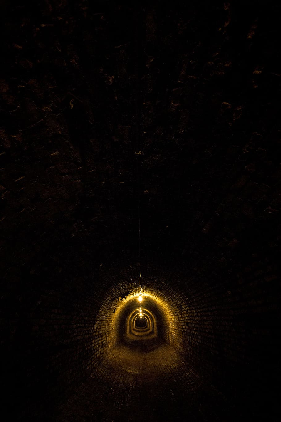yellow, lamp, hanging, ceiling, asylum, tunnel, underground, brick, shadows, dark