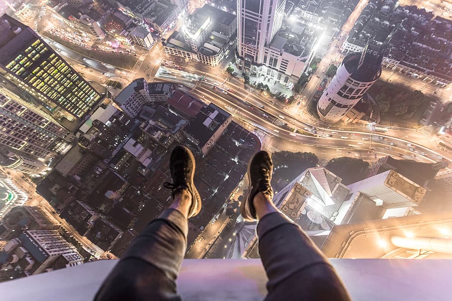 man, sitting, roof, city building, feet, shoes, hanging, edge, over the edge, people