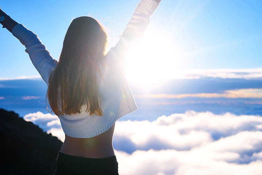 woman, wearing, white, bolero, lifting, arms, wide-open, looking, clouds, blue
