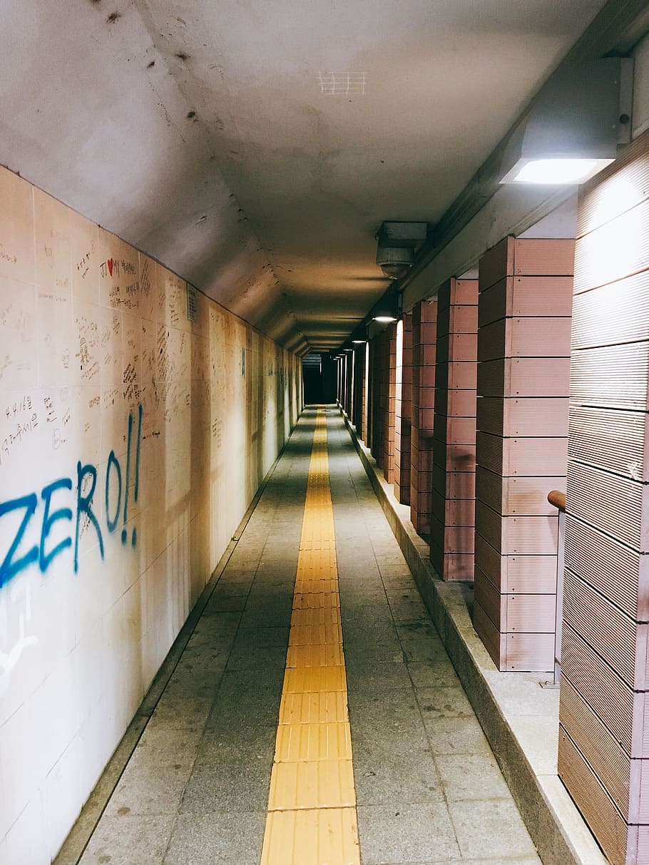 face, pathway, wall, graffiti, pedestrian underpass, a straight line, tunnel, architecture, the way forward, flooring