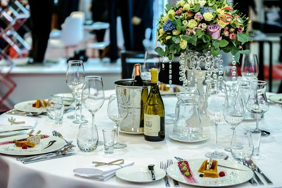 clear, wine glasses, plates, liquor bottles, table, flower centerpiece, dinnerware, set, white, restaurant