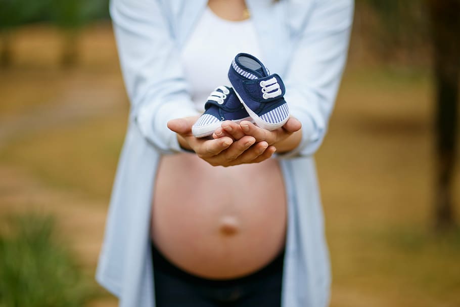 pregnant, woman, holding, baby, blue, shoes, pregnant woman, pregnancy, belly, mother