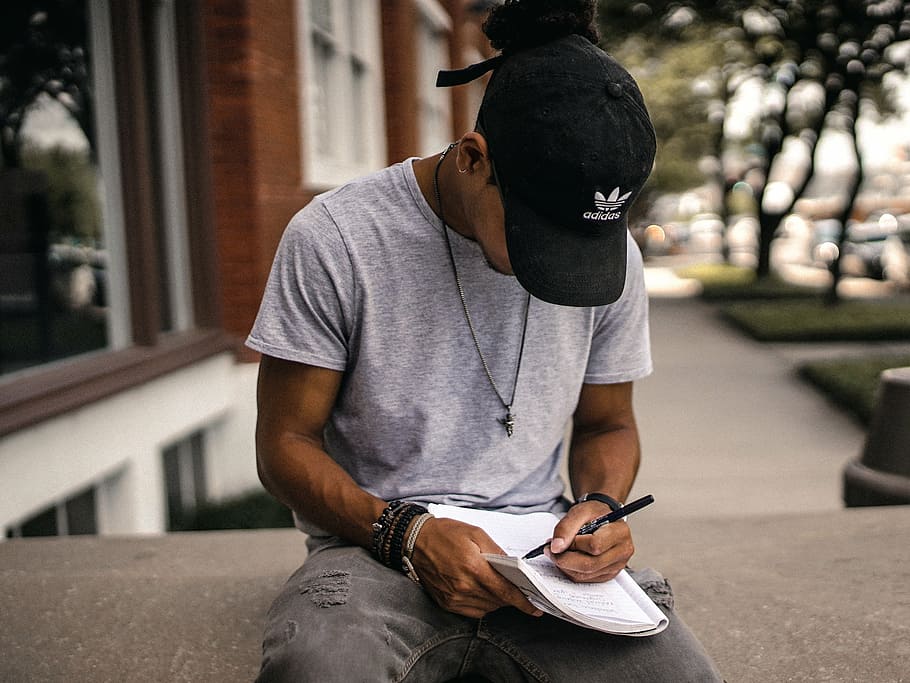 man, writing, book, building, people, guy, black, cap, hat, notebook