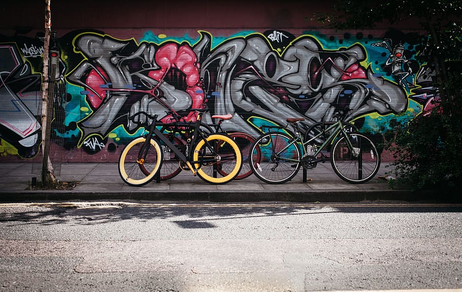 two, black, yellow, bikes, wall, graffiti, art, bicycles, pavement, road