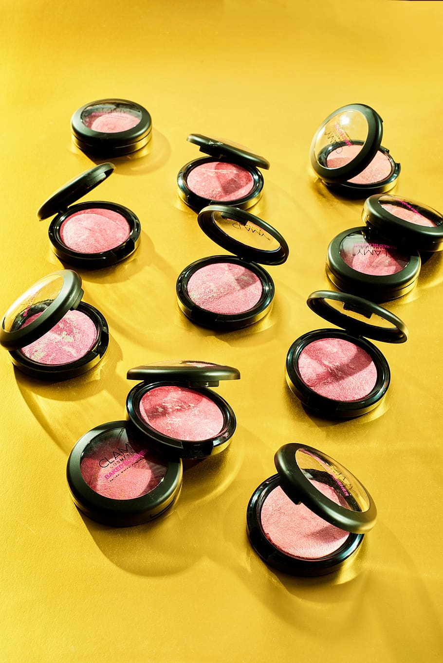 clamy blusher, clamy cosmetics, clamy makeup, blusher conceptual shoot, best blusher photograph, scattered makeup blushers, multi colored, variation, indoors, choice