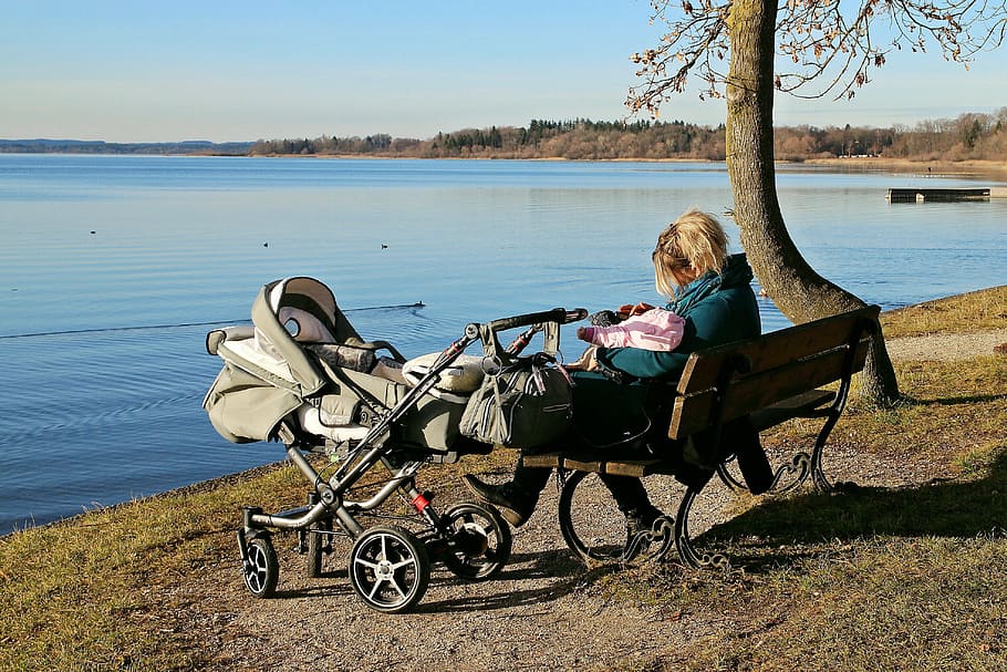 woman, sitting, bench, stroller, located, body, water, baby carriage, nature, lake