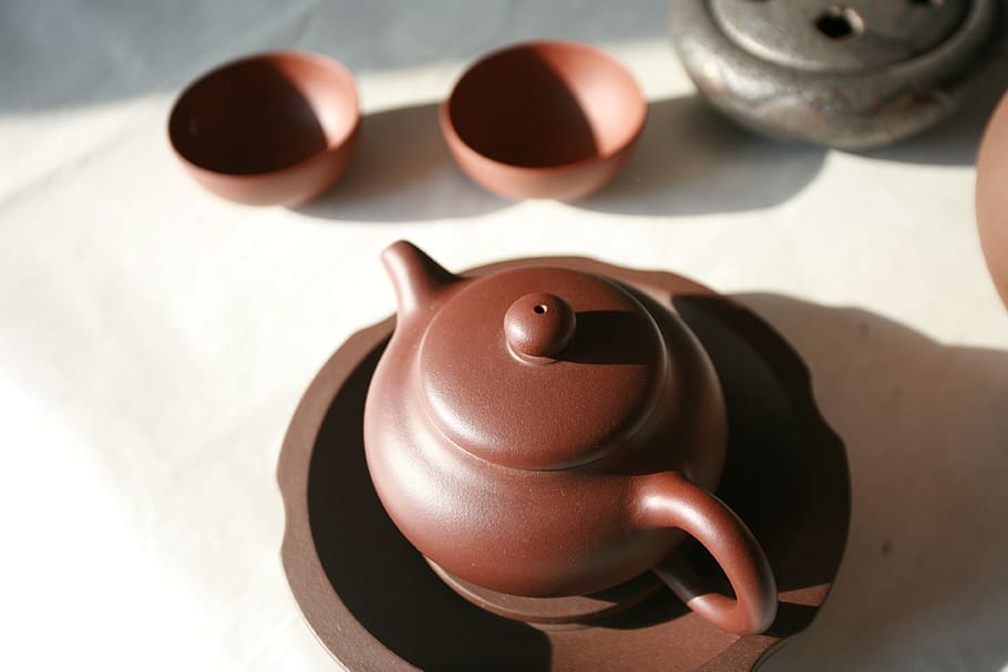 brown ceramic teapot, tea, tea set, teapot, pottery, ceramics, indoors, craft, art and craft, focus on foreground