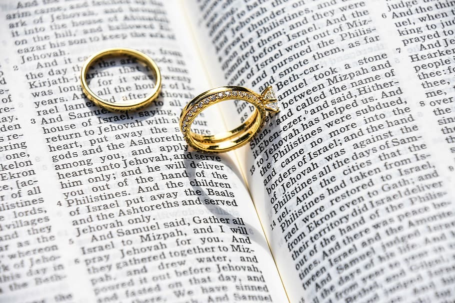 gold-colored wedding band, book, wedding, marriage, ring, bible, catholic, love, intimate, verses