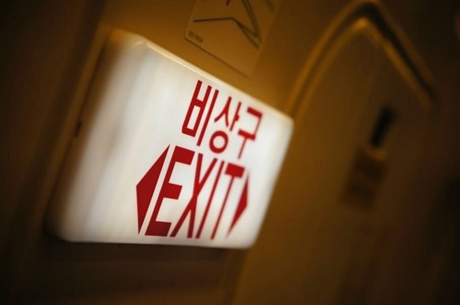 emergency exit, exit, plane, text, communication, western script, sign, indoors, close-up, finance