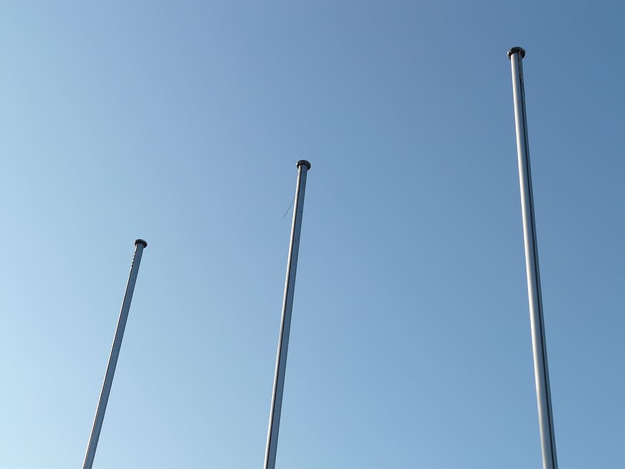 three, white, metal posts, blue, sky, flagpole, masts, empty, suspended, rod