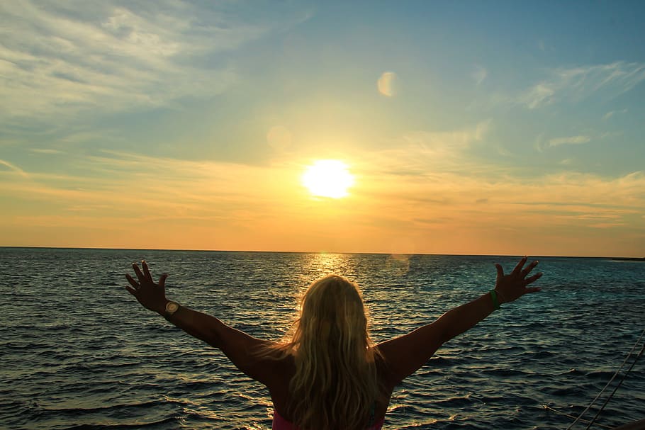 woman, raising, hands, facing, ocean, sunset, maldives, sea, sun, water