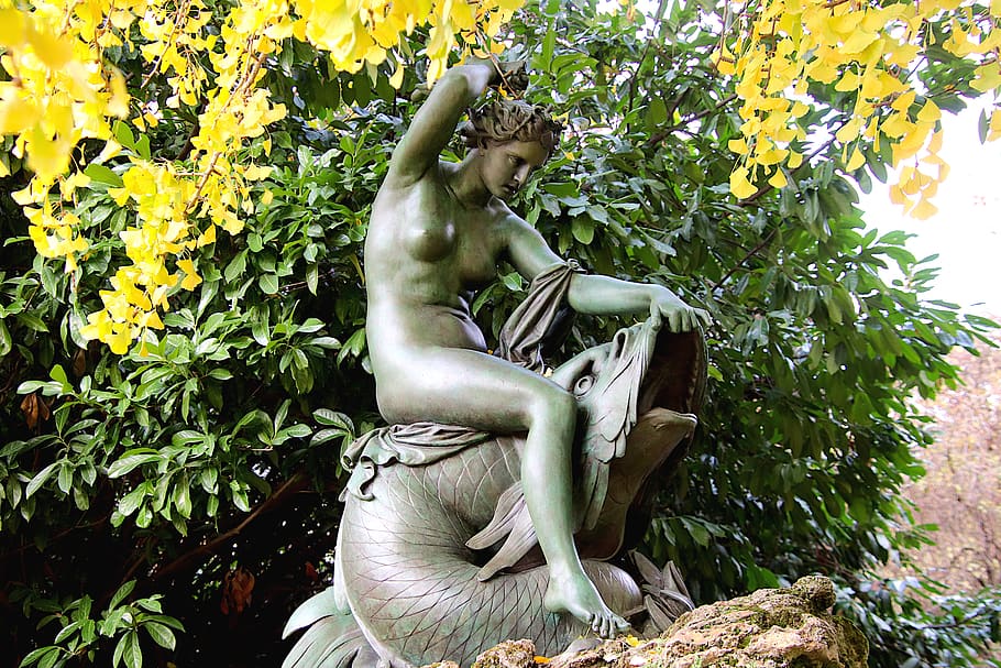 sculpture, statue, bronze green, young woman, fish, mythology, patina, public garden, trees, autumn leaves