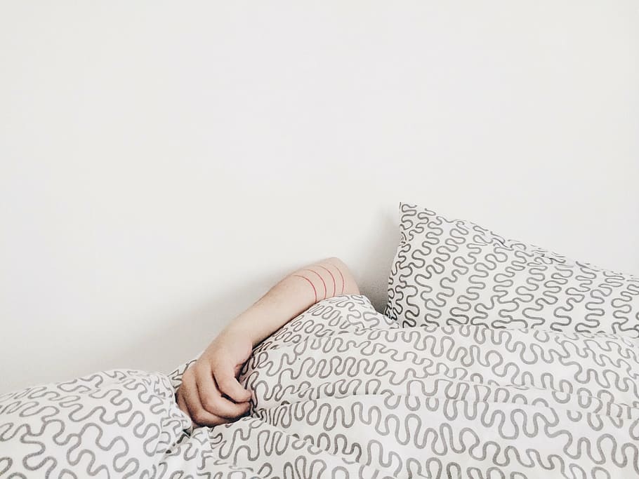 person, holding, white-and-gray textile, hand, bed, pillow, sheet, white, art, design