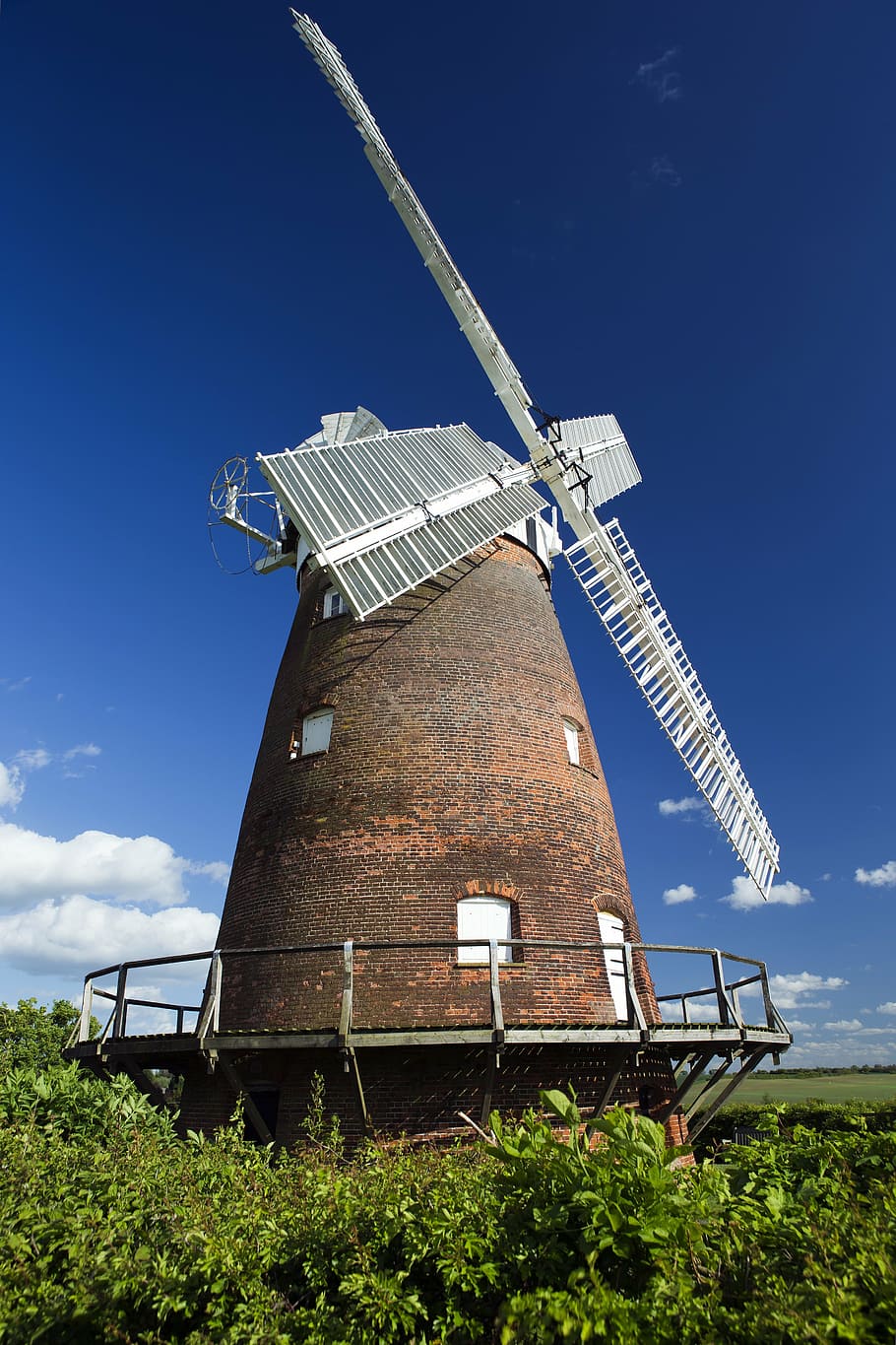thaxted, essex, england, restored windmill, constructed 1804, white sails, red brick, timber gallery, blue sky, windmill