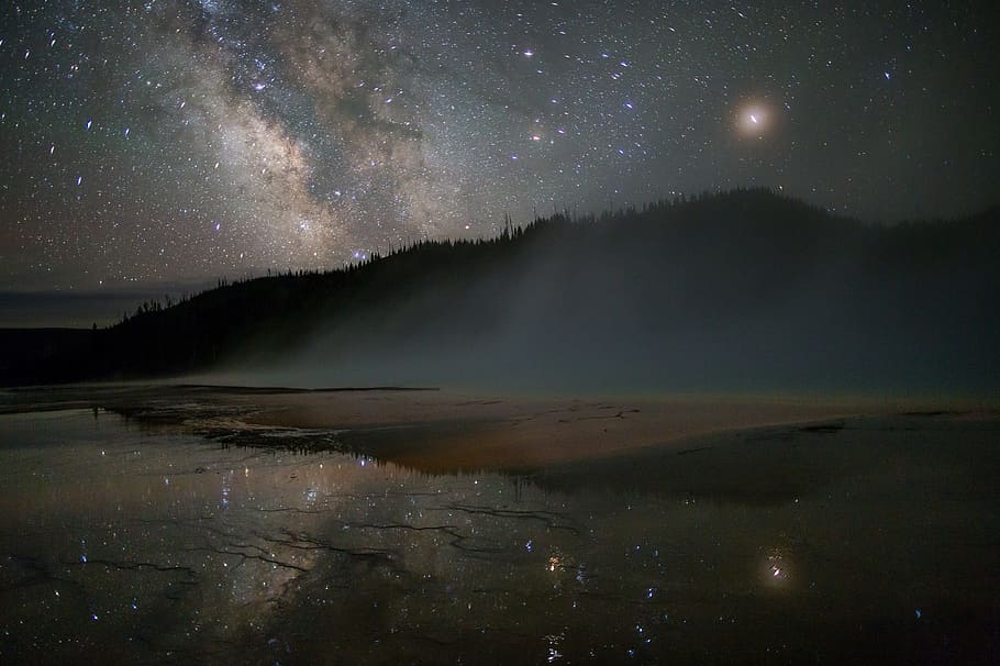 landscape photo, mountain, reflecting, body, water, night time, milky way, stars, sky, grand prismatic spring