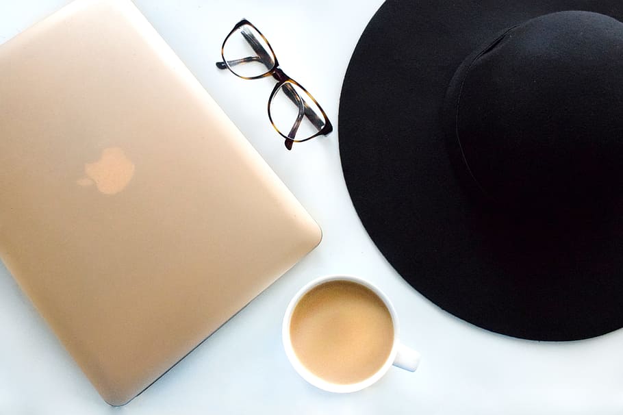 silver macbook, eye glasses, sun hat, caramel coffee, served, white, ceramic, mug, silver, MacBook