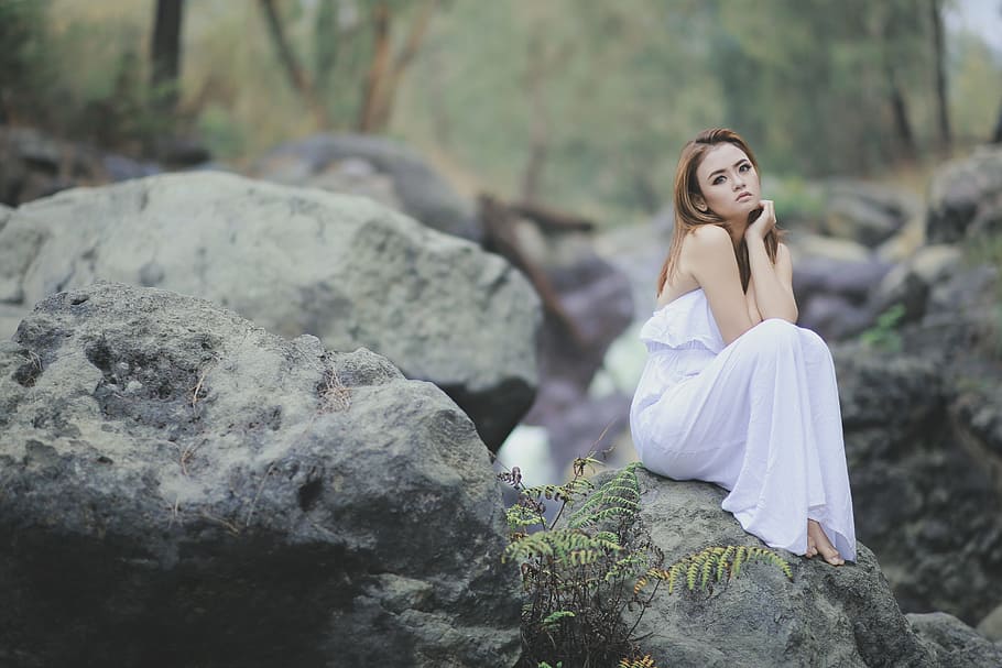 woman, wearing, white, strapless dress, sitting, stone, blushing, the rocks, forest, white dress