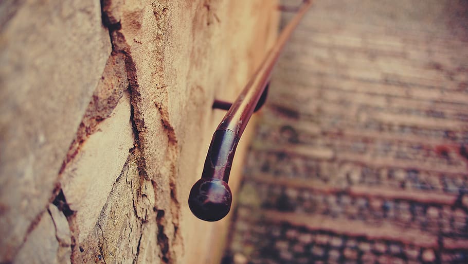 railing, brick, outdoors, stone, wood - material, metal, focus on foreground, close-up, wall - building feature, selective focus