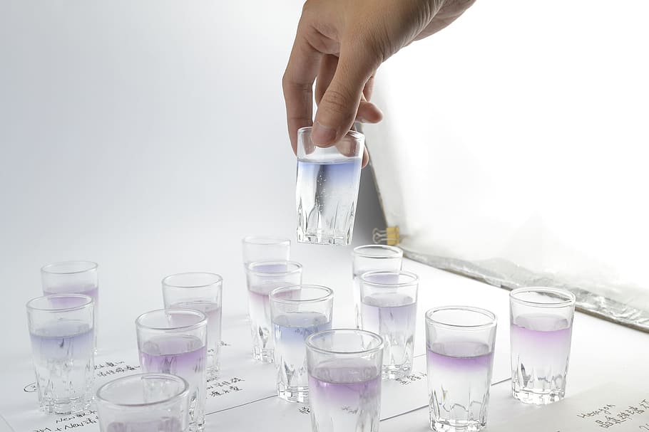 person, holding, drinking glass, filled, liquid, testing, experiment, science, test, chemistry